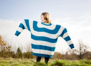 Girl wearing oversized jumper, arms out