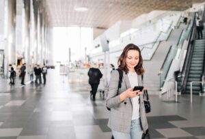 Attractive happy woman in the airport having recently relocated