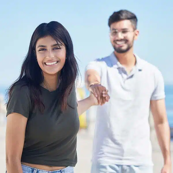 Nice looking couple smiling and holding hands on a sunny day.