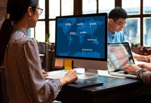 Business woman looking for virtual destinations on her computer