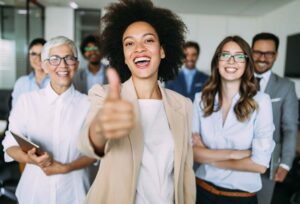 Group of successful business people with one stand out Talent Mobility employee out front giving a thumbs up