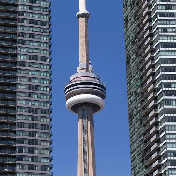 Toronto CN Tower pictured between two condo buildings