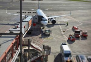 Airplane loading people and cargo at the gate