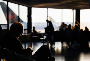 A Man working and waiting at an airport