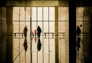 Reflection of a family in a long government Social Security hallway