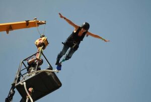 Woman bungee jumping from a platform