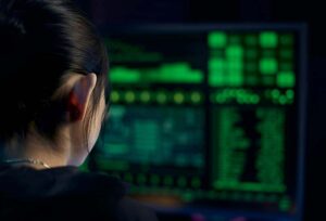 Female computer hacker in front of a green computer screen. The Threat No One Is Talking About: Procurement & Security Are About to Reshape Global Mobility in 2026