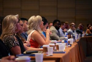 A group of people sitting at a conference